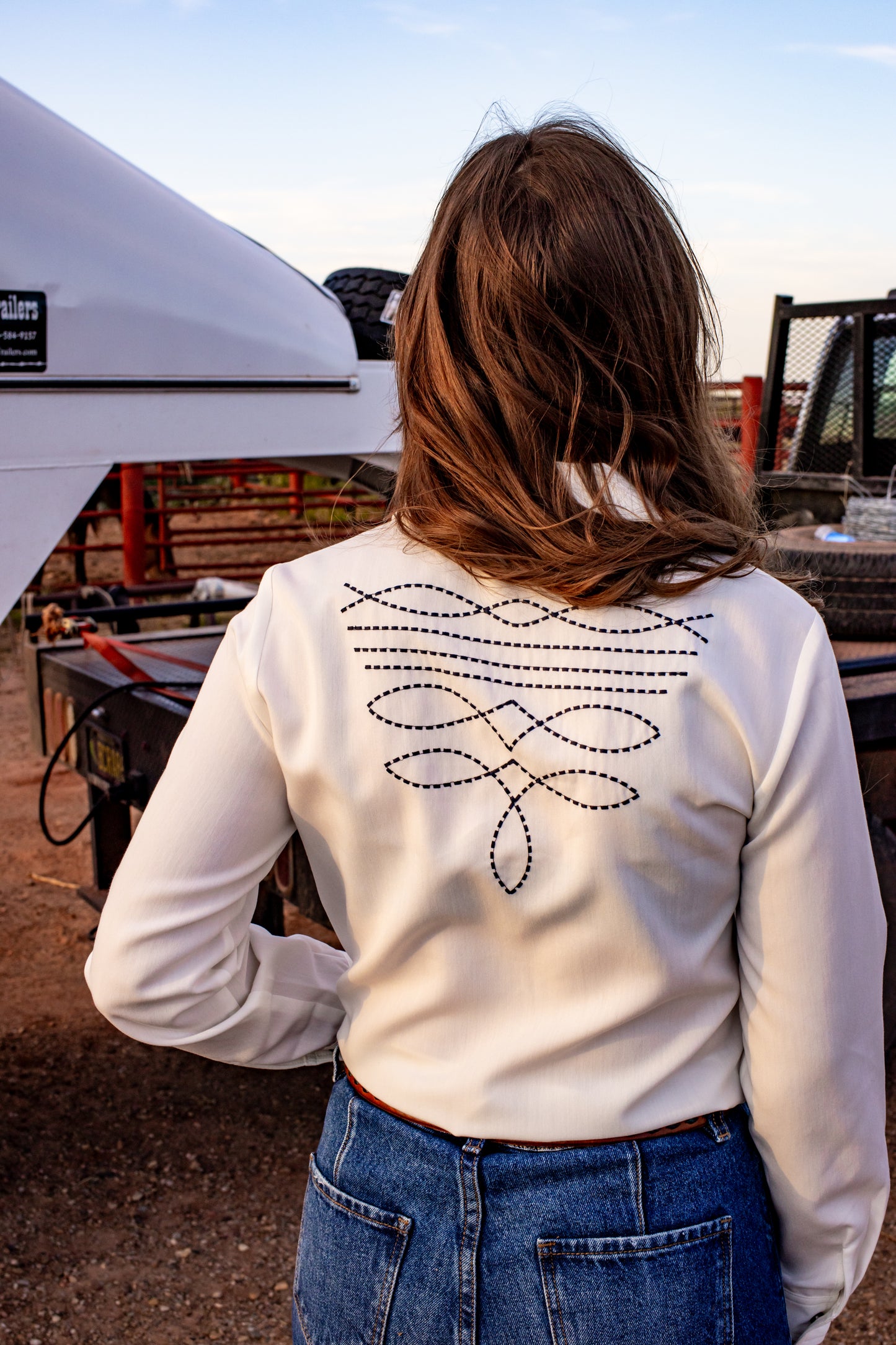 Boot stitch embroidered white top with turquoise snaps